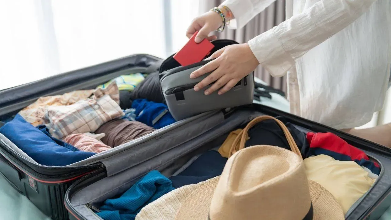 A traveller packing their things.