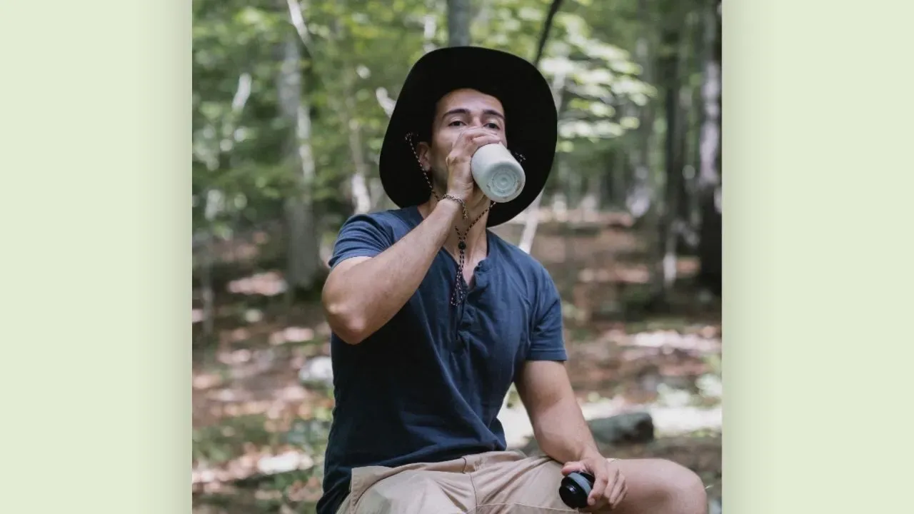 A tourist staying hydrated during his trip.