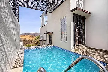 hotel with free parking in kaladwas, udaipur - elivaas shourya villa 3 bhk villa with swimming pool